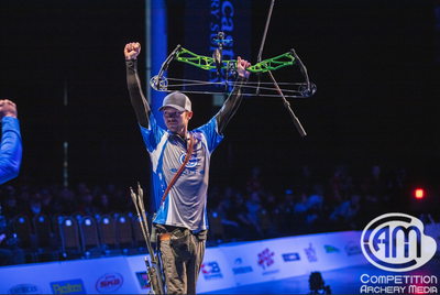 Nick Kappers holds his bow up in celebration of his Lancaster Archery Classic win.