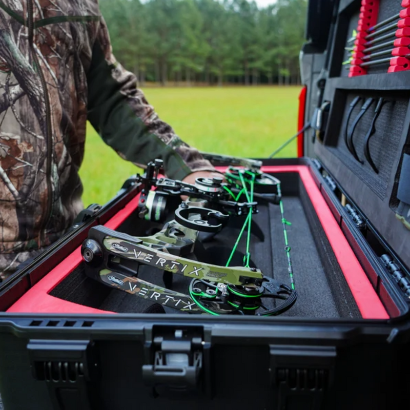 a mathews bow being placed in a heavy duty nanuk bow case.