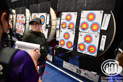 A young male archer calls out arrow scores to his bale mates for the first round of the tournament.