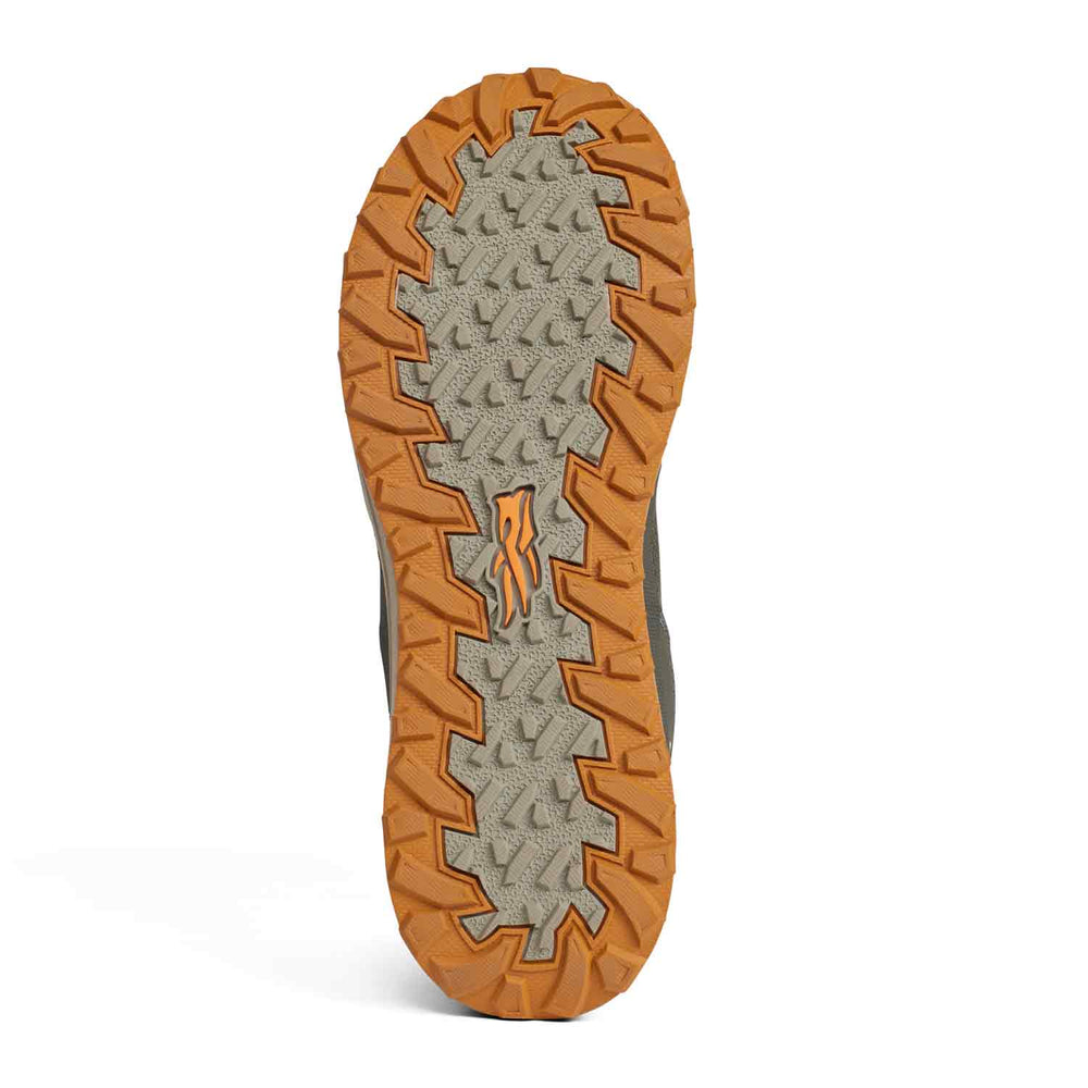 Close-up of a shoe sole with orange tread pattern on a white background