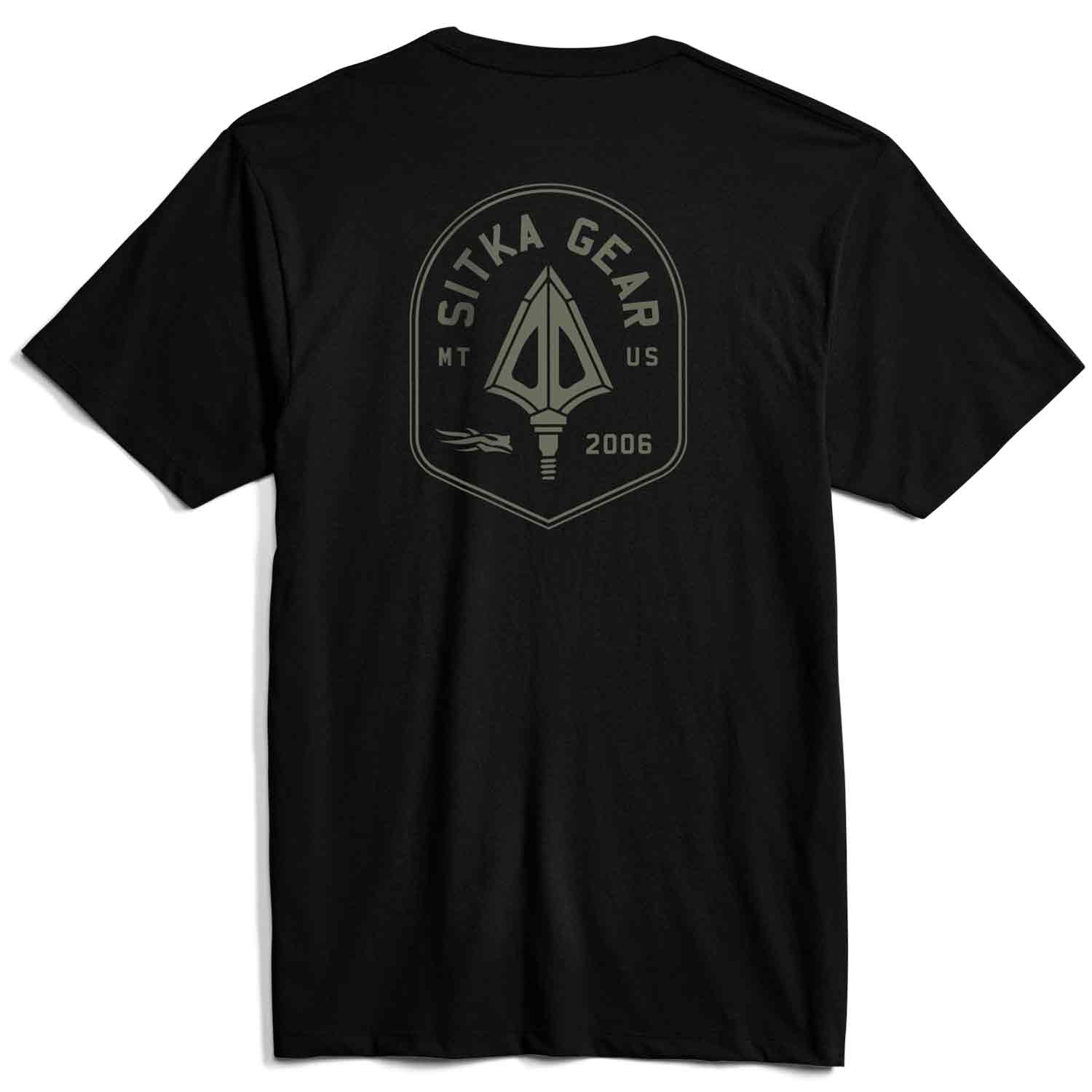 A black short-sleeve t-shirt shown from the back, featuring a muted olive green graphic print of an arrowhead inside a shield with the text 'SITKA GEAR', 'MT US', and '2006'.
