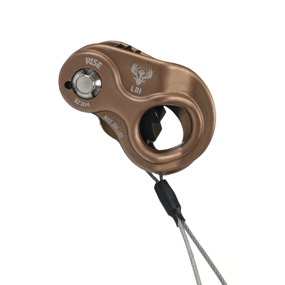 A bronze-colored aluminum climbing rope ascender with a black lanyard, featuring the LDI logo and 'RISE' text on a white background.