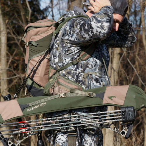 Green and brown elevation bow sling on a hunter's shoulder.