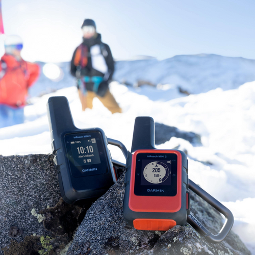 Garmin inReach Mini 2 in Flame orange on a rock surrounded by snow. 
