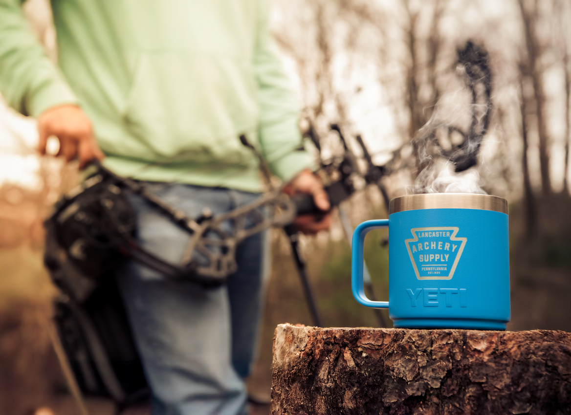 YETI Mug with compound archer in the background.
